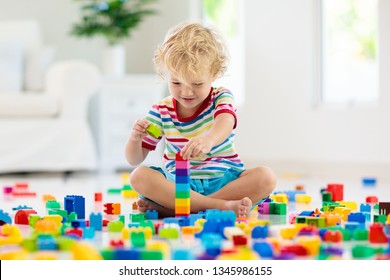 Child Playing With Colorful Toy Blocks. Little Boy Building Tower At Home Or Day Care. Educational Toys For Young Children. Construction Block For Baby Or Toddler Kid. Mess In Kindergarten Play Room.