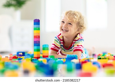 Child Playing With Colorful Toy Blocks. Little Boy Building Tower At Home Or Day Care. Educational Toys For Young Children. Construction Block For Baby Or Toddler Kid. Mess In Kindergarten Play Room.