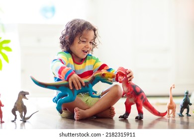 Child Playing With Colorful Toy Dinosaurs. Educational Toys For Kids. Little Boy Learning Fossils And Reptiles. Children Play With Dinosaur Toys. Evolution And Paleontology Game For Young Kid.