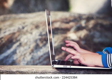 Child Playing With Computer In The Park. Parenting Apps And Child Control Idea