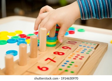 Child Playing With Different Color Wooden Rings. Sequence, Fine Motor Skills, Therapy Task For Education And Brain Exercise. Counting Math Play Game.  Montessori Type Implement. Wooden Toys.