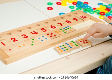 Child Playing With Different Color Wooden Rings. Sequence, Fine Motor Skills, Therapy Task For Education And Brain Exercise. Counting Math Play Game.  Montessori Type Implement. Wooden Toys.