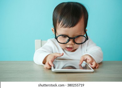 Child playing with digital tablet on the blue background