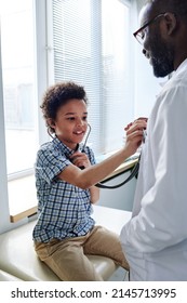 Child Playing With Doctor At Hospital