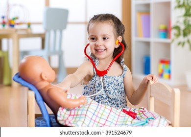 Child Playing Doctor With Toy At Home