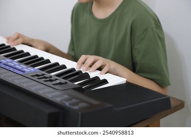 Child playing electric keyboard. Boy in music classes. Music lessons with background with copy space. Student in classes.  Musical child.	
 - Powered by Shutterstock