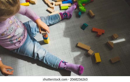 Child Playing Falling From Building Blocks