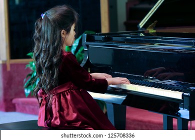 Child Playing Grand Piano In Formal Dress