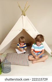 Child Playing At Home Indoors With A Teepee Tent