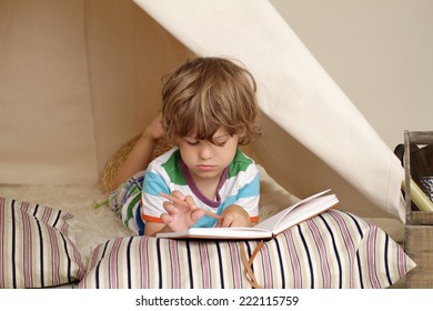 Child playing at home indoors with a teepee tent - Shutterstock ID 222115759