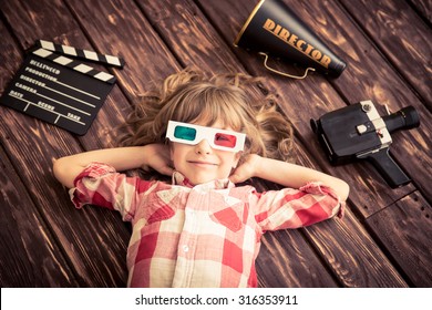 Child Playing At Home. Kid With Vintage Cinema Objects. Entertainment Concept. Top View