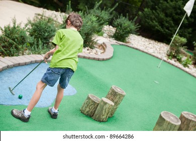 Child Playing Miniature Golf