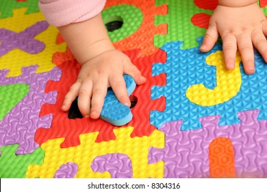child playing multi colored alphabet puzzle