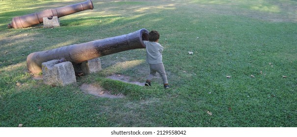 Child Playing With Old Cannon, Arm Inside Cannon Barrel