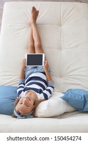 Child Playing On Ipad Tablet Pc On The Sofa At Home, Top View Point