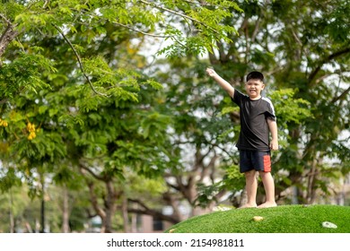 Child Playing On Outdoor Playground. Kids Play On School Or Kindergarten Yard. Active Kid On Colorful Slide And Swing. Healthy Summer Activity For Children. Little Boy Climbing Outdoors.Soft Focus