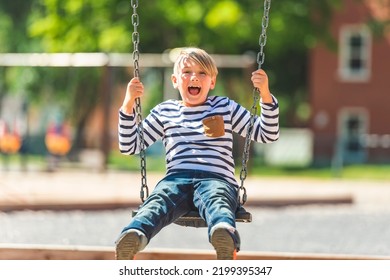 A Child Playing On Outdoor Playground. Kids Play On School Or Kindergarten Yard