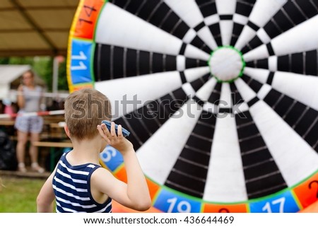 Similar – Image, Stock Photo Child throwing dart at balloons