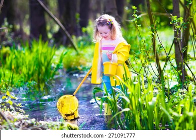 Child playing outdoors. Preschooler kid catching frog with colorful net. Little girl fishing in a forest river. Adventure kindergarten day trip into wild nature, explorer hiking and watching animals. - Powered by Shutterstock