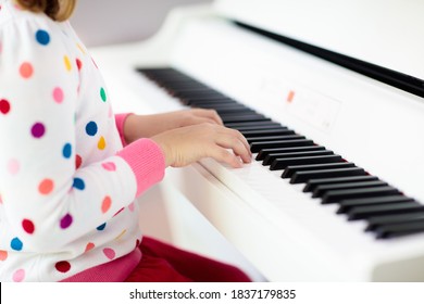 Child Playing Piano. Kids Play Music. Classical Education For Children. Art Lesson. Little Girl At White Digital Keyboard. Instrument For Young Student. Music Class In School Or At Home.