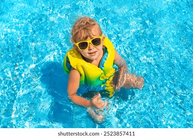 Child playing in the pool. Selective focus. Kid. - Powered by Shutterstock