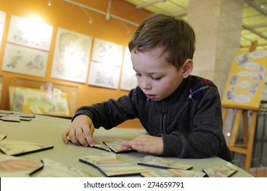 Child playing with puzzle in the classroom