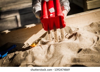 Child Playing In Sand Box