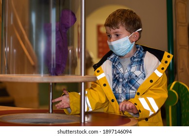 A Child Playing In A Science Center