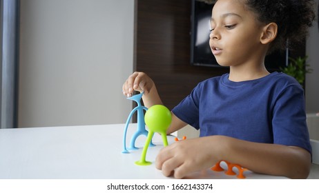 A Child Is Playing With Sensory Toys