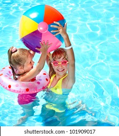 Child playing in swimming pool. Summer outdoor.