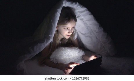 Child Playing Tablet in Dark Night, Girl Browsing Internet in Bed, Not Sleeping 