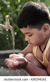 Child Playing With Tap Water Outdoor