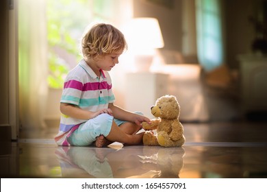 baby holding teddy bear