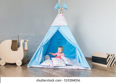 Child Playing With A Teepee Tent