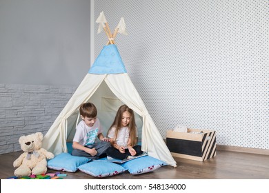 Child Playing With A Teepee Tent