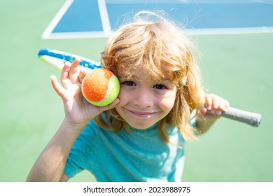 Child playing tennis on outdoor court. Little girl with tennis racket and ball in sport club. Active exercise for kids. Summer activities for children. Training for young kid.