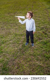 Child Playing Throwing A Paper Airplane