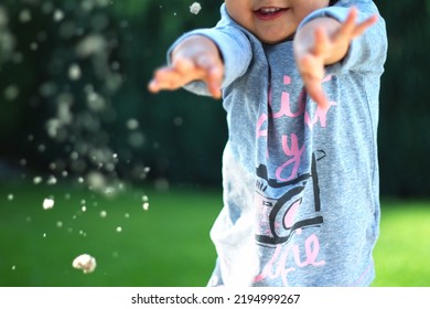 A Child Is Playing, Throwing Sand