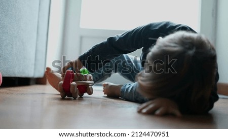 Child playing with toy at home
