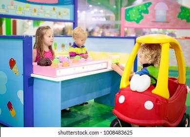 Child Playing In Toy Shop Or Restaurant. Educational Toys And Role Game For Kids. Kindergarten Or Preschool Play Room. Toddler Kid At Day Care Playground. Grocery Store Or Supermarket For Children.