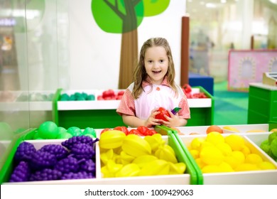 Child Playing In Toy Shop Or Restaurant. Educational Toys And Role Game For Kids. Kindergarten Or Preschool Play Room. Toddler Kid At Day Care Playground. Grocery Store Or Supermarket For Children.