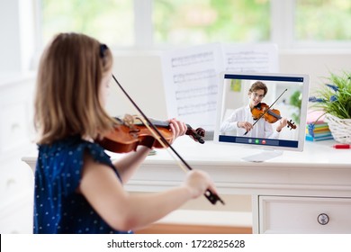 Child playing violin. Remote learning from home. Arts for kid. Little girl with musical instrument. Video chat conference lesson. Online music tuition. Creative children play song. Classical education - Shutterstock ID 1722825628