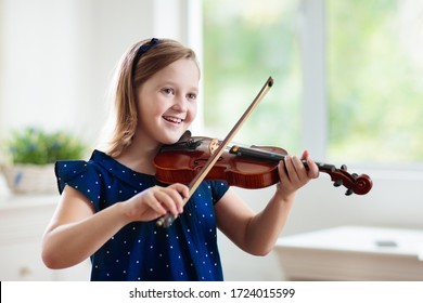 Child Playing Violin. Remote Learning From Home. Arts For Kid. Little Girl With Musical Instrument. Video Chat Conference Lesson. Online Music Tuition. Creative Children Play Song. Classical Education