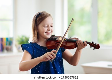 Child Playing Violin. Remote Learning From Home. Arts For Kid. Little Girl With Musical Instrument. Video Chat Conference Lesson. Online Music Tuition. Creative Children Play Song. Classical Education