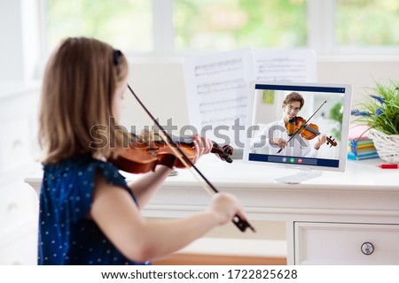 Child playing violin. Remote learning from home. Arts for kid. Little girl with musical instrument. Video chat conference lesson. Online music tuition. Creative children play song. Classical education