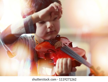 Child Playing The Violin In  Room