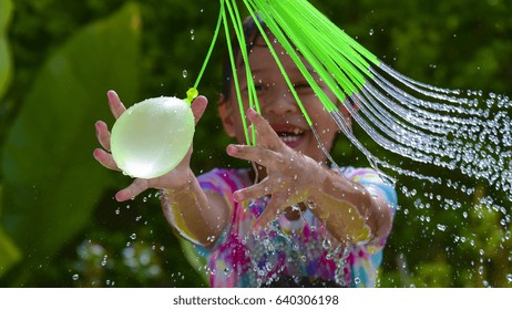 Child Playing  Water Balloons.