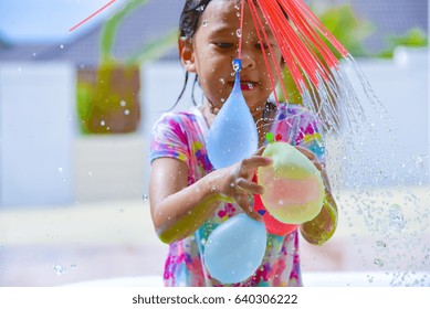 child playing water balloons.