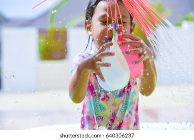 Child Playing  Water Balloons.