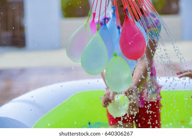 Child Playing  Water Balloons.